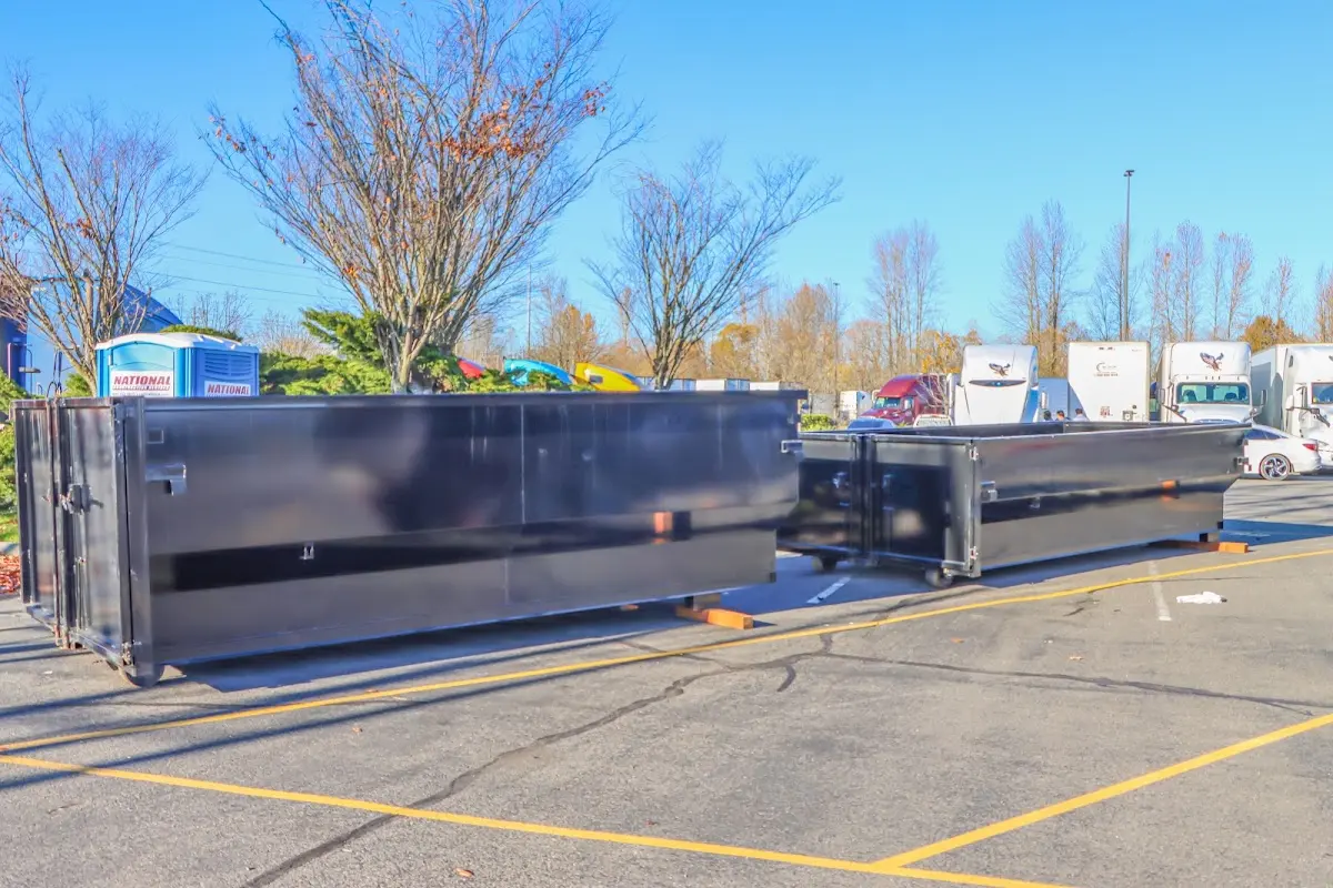 Professional dumpster rental service with roll-off container on residential driveway in Duncan